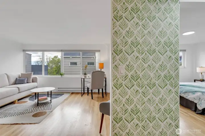This photo shows another view into the living room on the left and on the right into the bedroom.