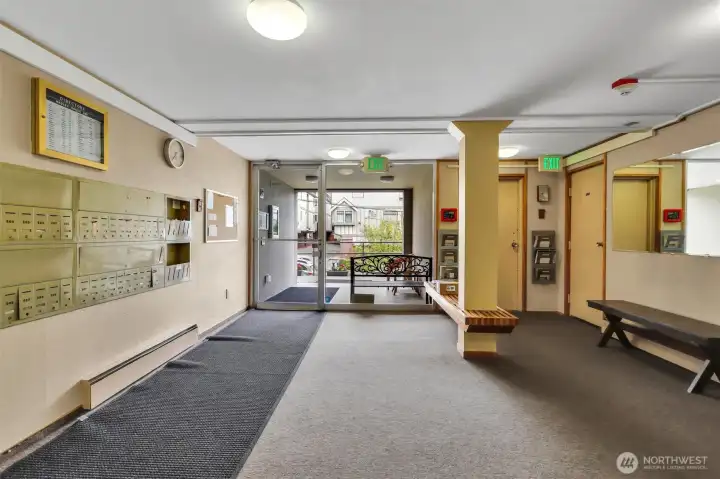 Hadley House has a secure entrance, mailboxes, and a locked package room. To the right of this photo is the elevator.