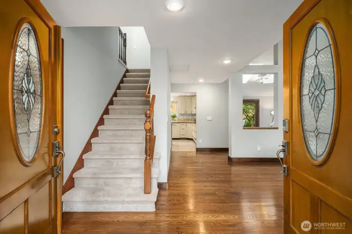 The grand entry welcomes you with soaring ceilings, beautiful hardwood floors, and elegant double doors that set the tone for the warmth and quality found throughout this exceptional home.