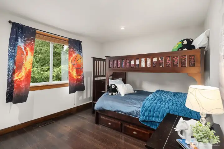 This fun and characterful bedroom features rich built-in bunk beds and vibrant natural light, making it a perfect and imaginative space for kids.