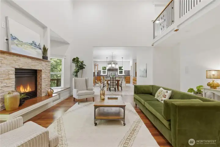 Family room with vaulted ceilings and gas fireplace. Home is staged.