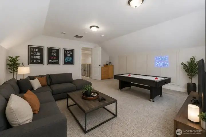 Upper-level bonus room with wet bar. Virtually staged.