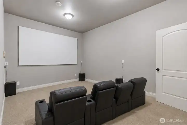 Basement theater with virtually staged seating.