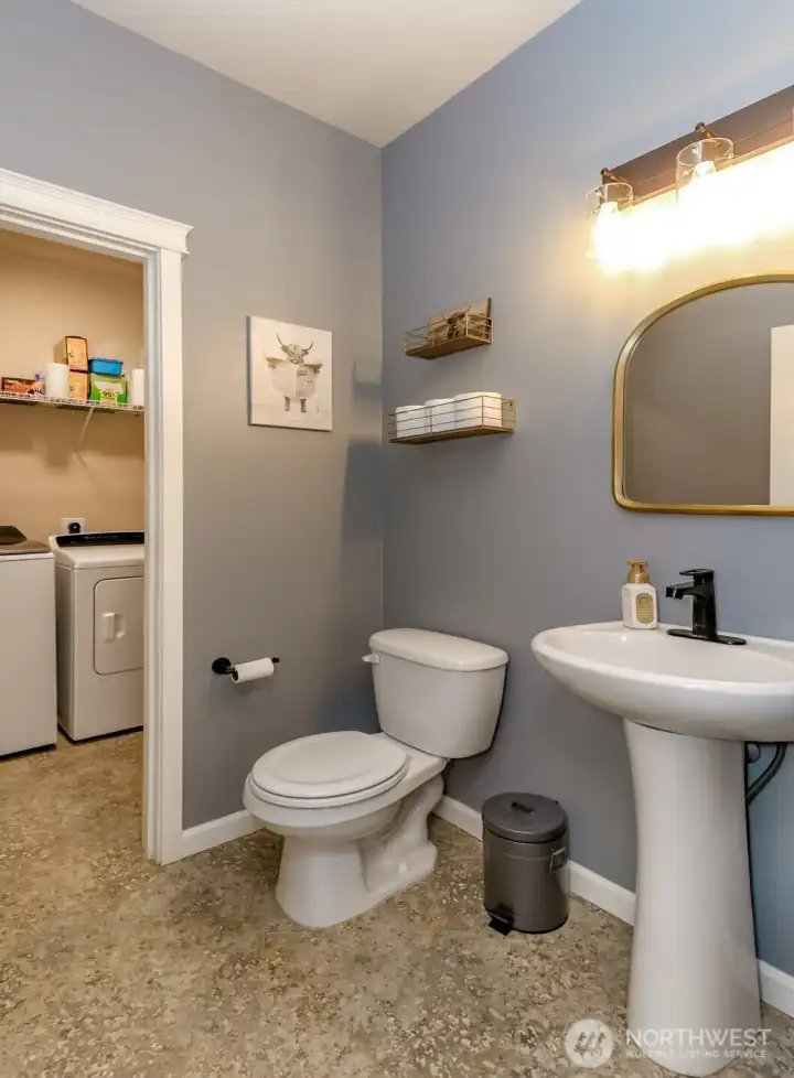 Downstairs half bath also entry into laundry room