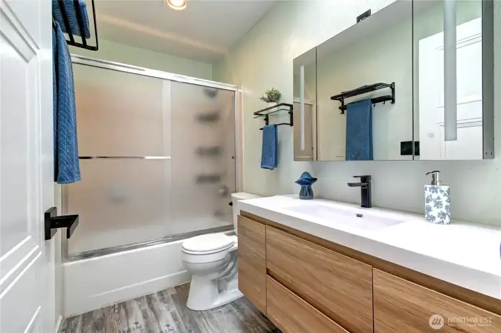 The second bath is also beautifully updated with a new vanity, skylight, and fixtures. The second bath is also beautifully updated with a new vanity, skylight, and fixtures.
