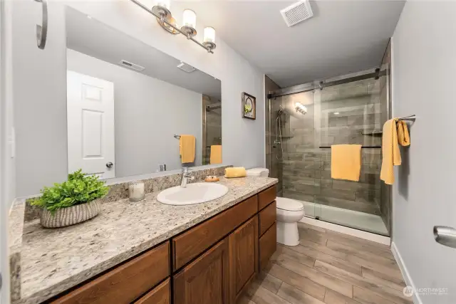 Transforming function into form: A stylish 3/4 bath adjacent to the versatile bonus room, ready to seamlessly transition from office to guest retreat.