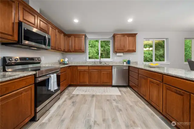 Modern elegance meets practicality in this spacious kitchen, complete with sleek stainless steel appliances, abundant storage, and luxurious granite countertops. Cooking has never felt so stylish and effortless.