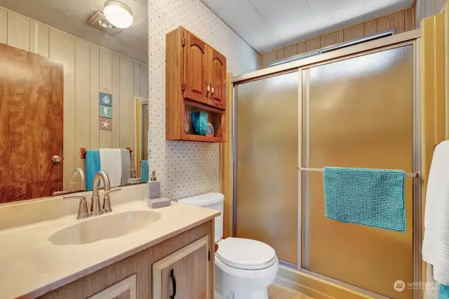 Step in shower with seating in the guest bathroom.