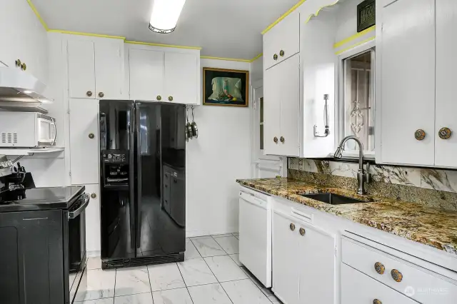 Here's a look back at the kitchen, with granite countertop and stainless sink with disposal.