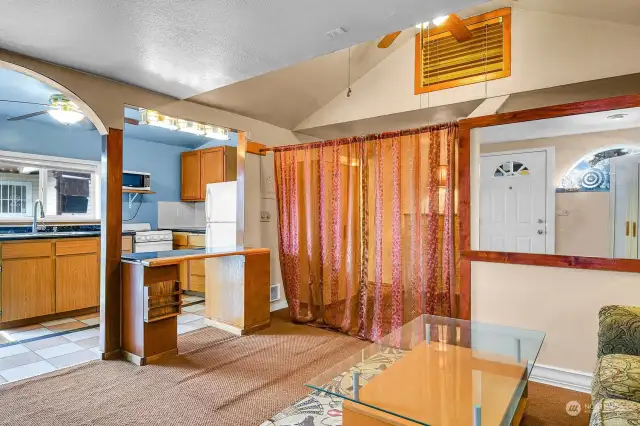 You can close off the bedroom from the living room with curtains. The louvred "window" behind the ceiling fan is a storage area that goes all the way through to the bedroom side.