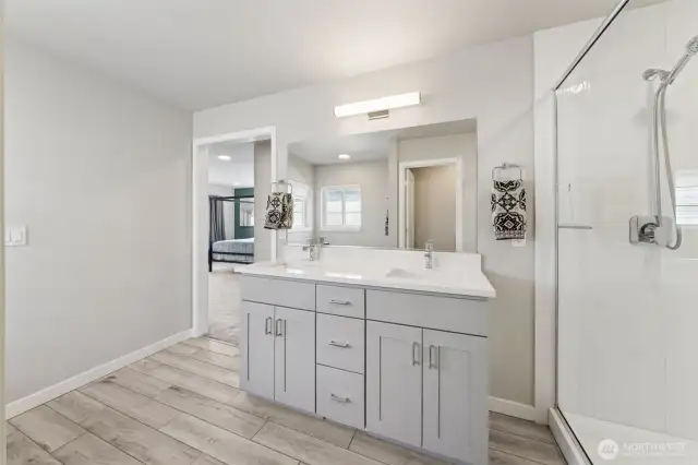 Another view of the Primary bath showcasing the ceramic tile floors that look like wood for that spa-like experience.