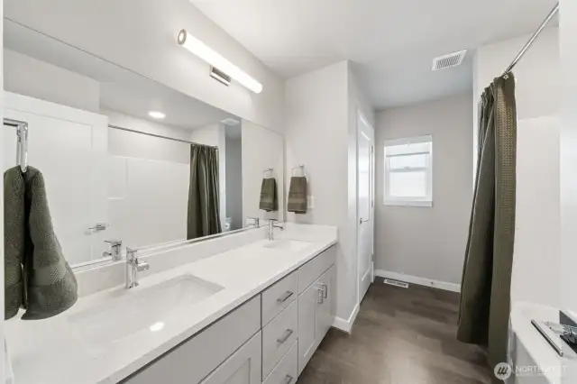Full bath with double sinks & dedicated linen closet.
