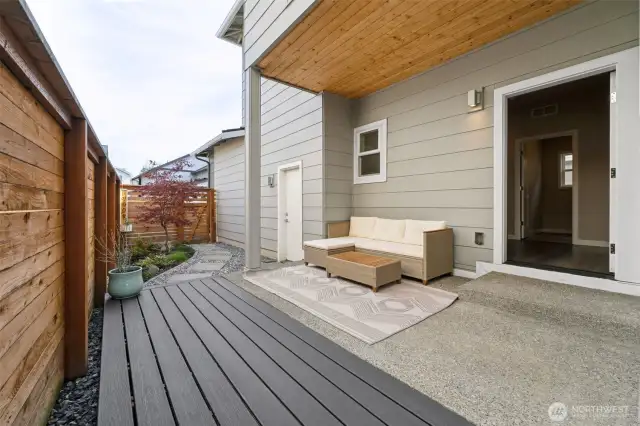 Back yard with covered patio, extended deck and fully fenced.