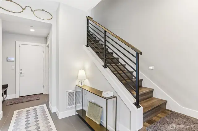 Entry hall with garage door ahead and guest room to the left
