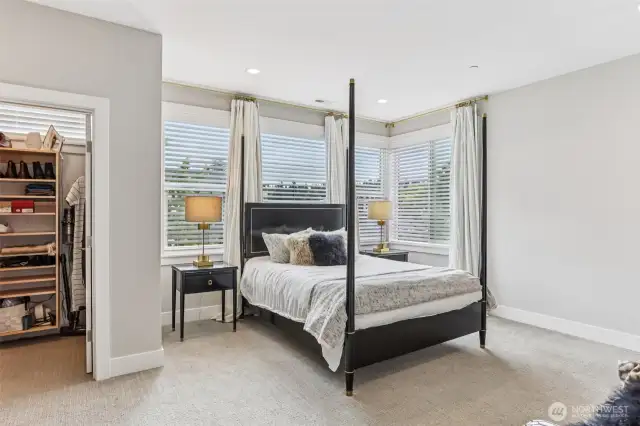 Enter the primary suite with it's north east exposure.