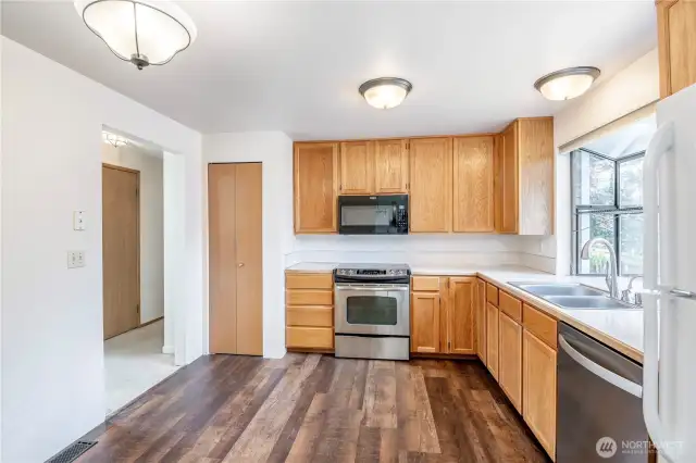 Kitchen with matching stainless steel appliances and newer vinyl plank flooring