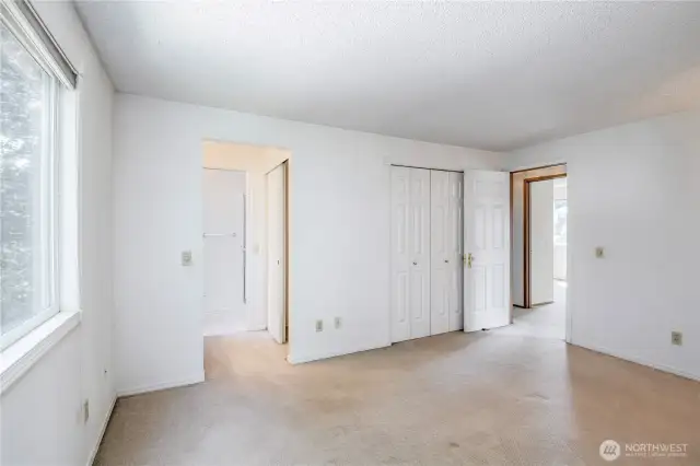 2 closets in the primary suite with a separate mirror/sink area from the toilet/shower