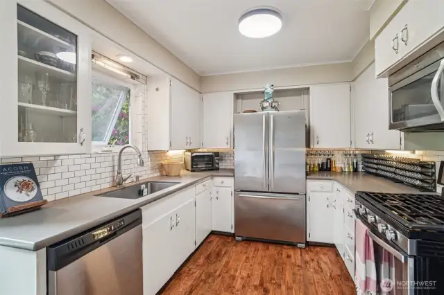 Modern high end appliances, gas stove, tile; yet charming vintage feel.