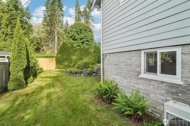Side yard with fence onto street. Was once a driveway. Potential to reinstate & use as separate driveway/ RV parking to basement entrance.