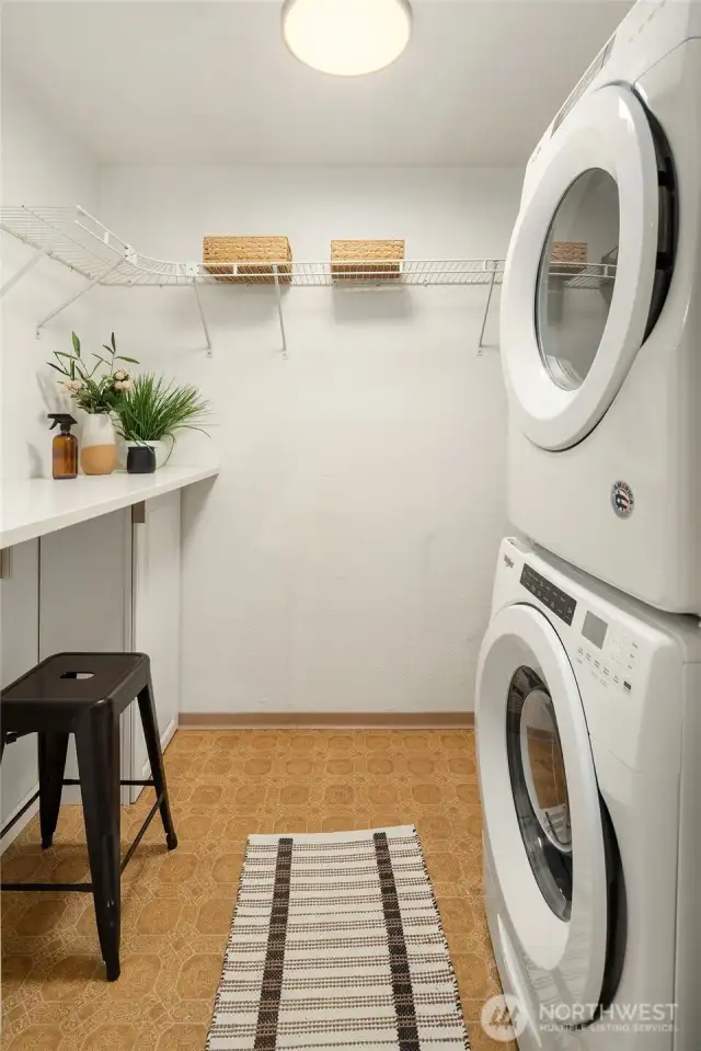 The laundry room with newer stackable washer/dryer and plenty of storage space.