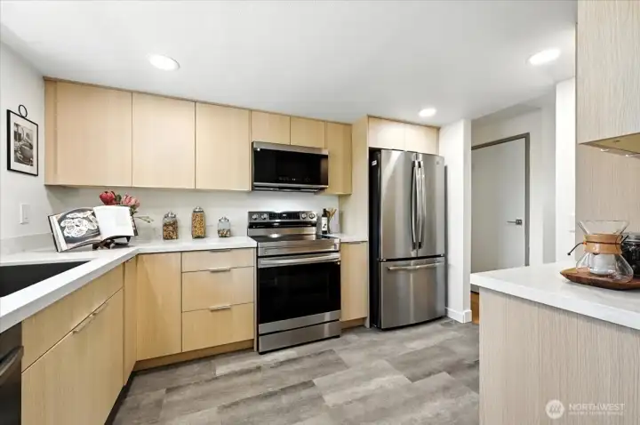New cupboards with quartz countertops. Desirable luxury vinyl plank makes this kitchen complete.