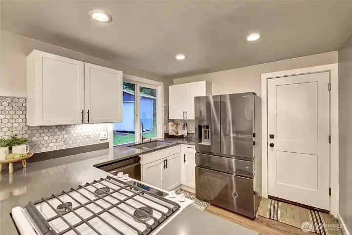 Access to the double car garage can be found in the kitchen.