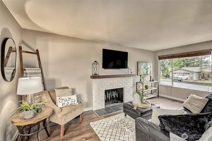 Living room with wood burning fireplace.