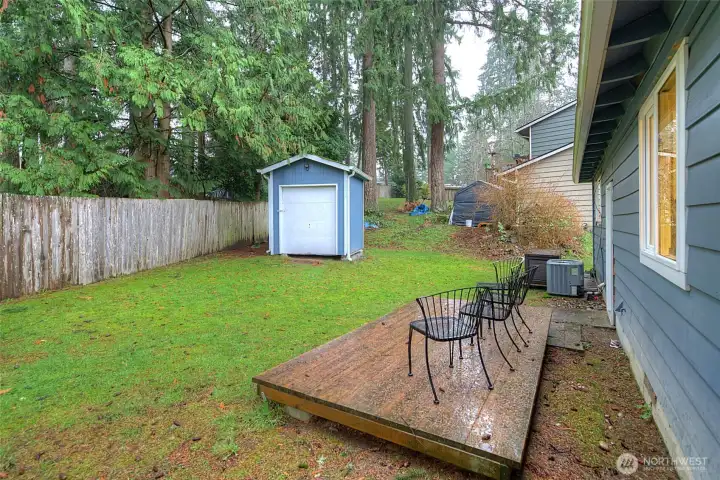 The back yard is partially fenced with a small wood deck and an outbuilding for additional storage. This home also has central A/C.