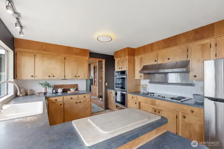 The kitchen, looking towards the doorway into the dining room.  There is a small area behind me with space for a 4-6 person breakfast table.