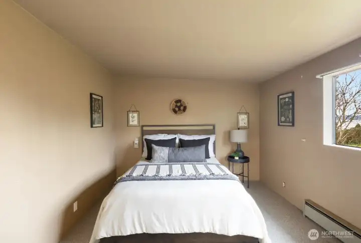 Here is the primary bedroom:  Small, but extravagant considering the 1943-era construction.  It has a separate walk-in closet and primary bathroom that makes it very livable and more spacious.