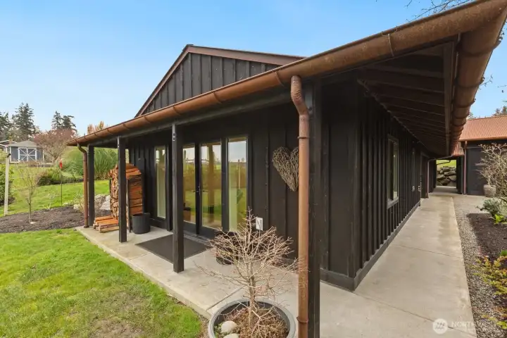 The unfinished basement awaits your design and touch, but with limited space here, lets move on to the garage and shop.  You can see the breexeway that separate the two outbuildings.  Note the combination of the custom shou sugi finish on the cedar, and patina of the metal roof!  All by design, it's the first time I've ever seen this finish.  It's so impressive!