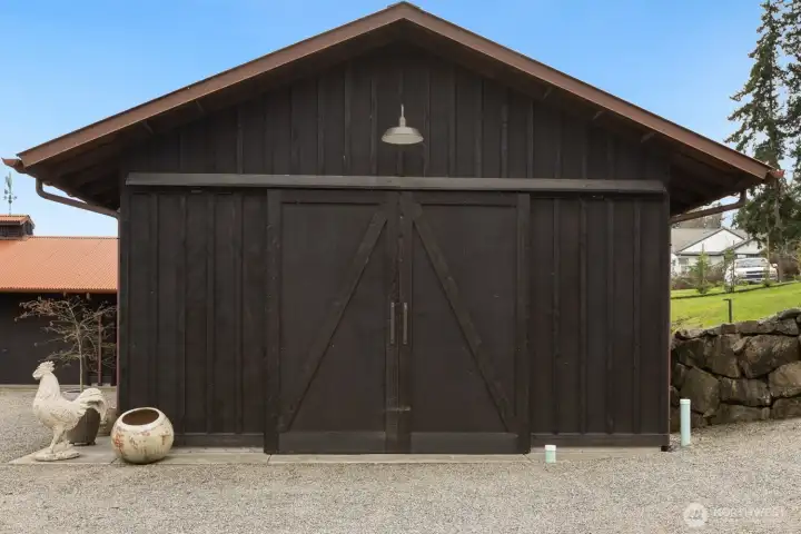 The workshop and garage feature the shou sugi ban” finish with patina on rooftop-what a stunning combination!