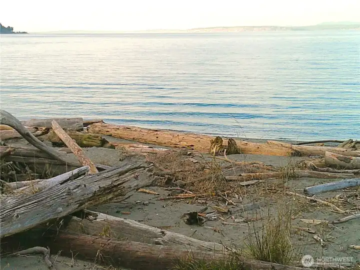 25' of shared common area to Puget Sound's saltwater!  Perfect for picnics, hand-launching boats and kayaks, and a short walk from the house to watch shipping traffic, sunrise and sunset!  Whidbey Island's Sachet Head and Possession bar are in the background.  This property is offered with so many assets, you don't want to miss it!