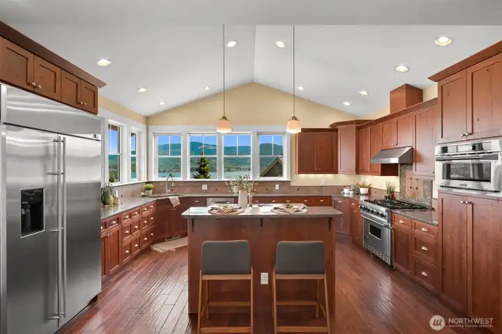 Kitchen with commercial grade appliances and granite countertops with hand scraped oak hardwood flooring