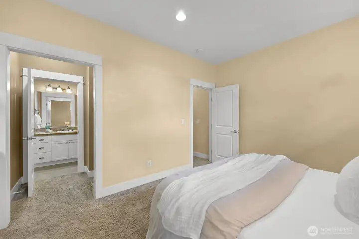 Secondary suite with private walk-in closet and full bath-previously staged