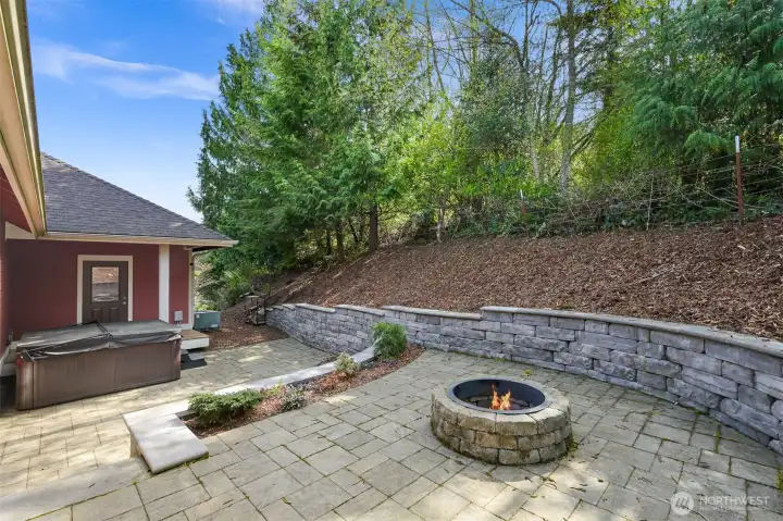Fire pit and hot tub in professionally terraced back yard