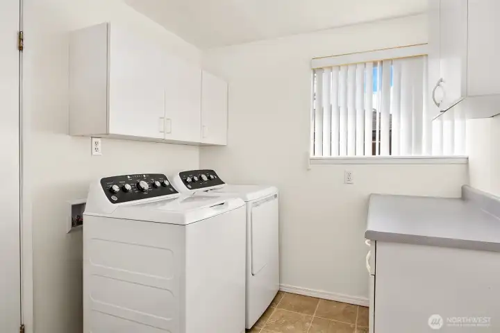 Spacious laundry room with lots of storage between Living Room and Garage.