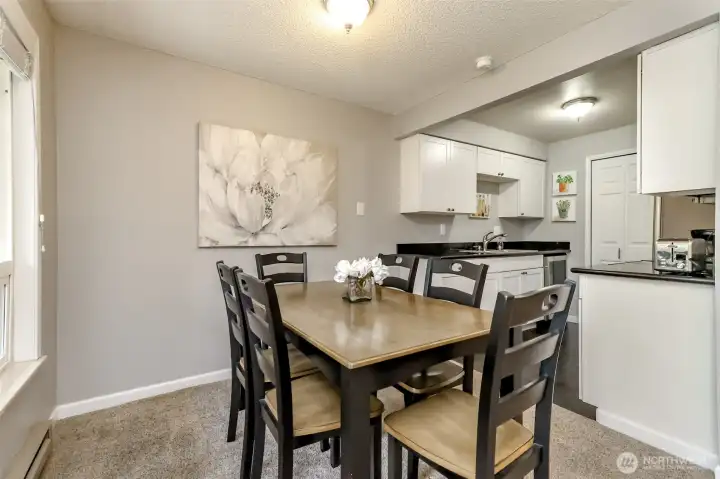 Bright dining area with large window views and space for a full dining table.