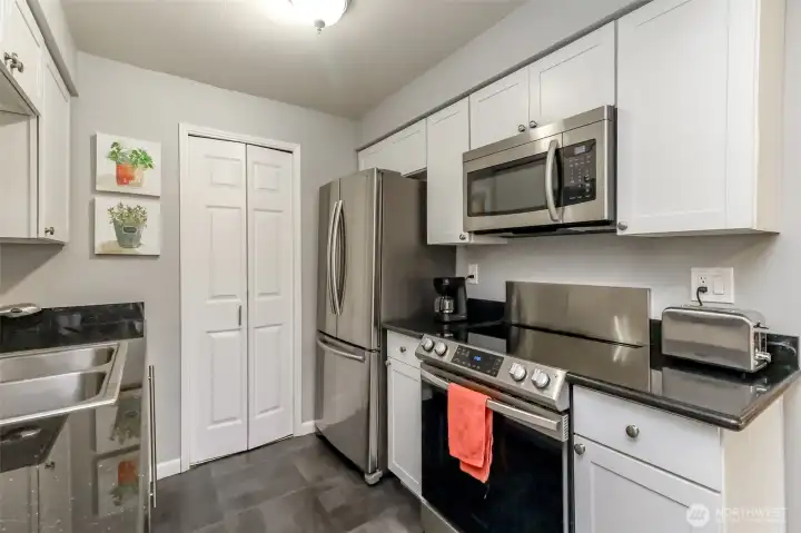 Updated kitchen with white cabinetry, stainless steel appliances, and efficient layout for cooking.