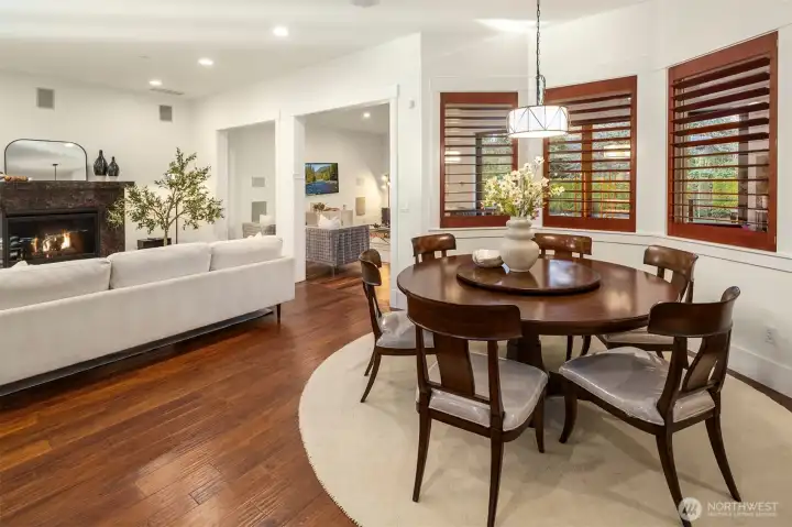 Open dining and family room with a warm fireplace—perfect for everyday living and effortless entertaining.