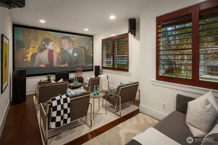 Open media space with projector and large screen—ideal for immersive movie nights.