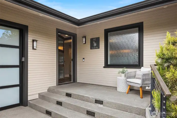 A quiet, welcoming arrival—covered, composed, and thoughtfully scaled. A place to pause before stepping inside, where the tone of the home begins with intention and ease.