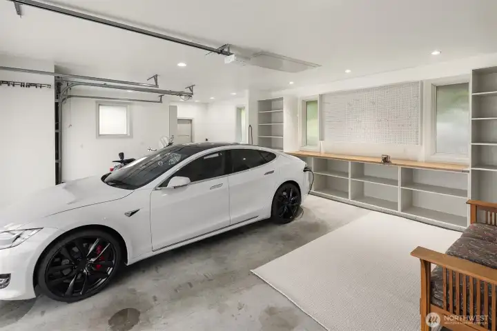 Expanded to a 3-car garage with a repoured slab, modern doors, and custom built-ins. EV charging capability and an invisible fence system complete a space designed for ease, utility, and clean execution.
