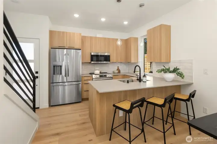 Ample countertop space and cabinets in well-appointed kitchen