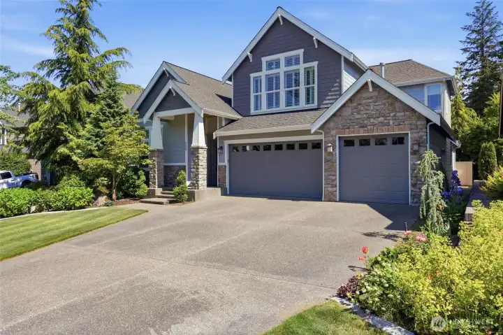 3 car garage with a large driveway