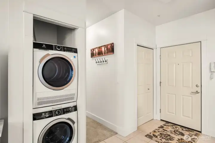Stackable washer/dryer area. Hallway to bedroom/bathroom is to the right of the washer/dryer