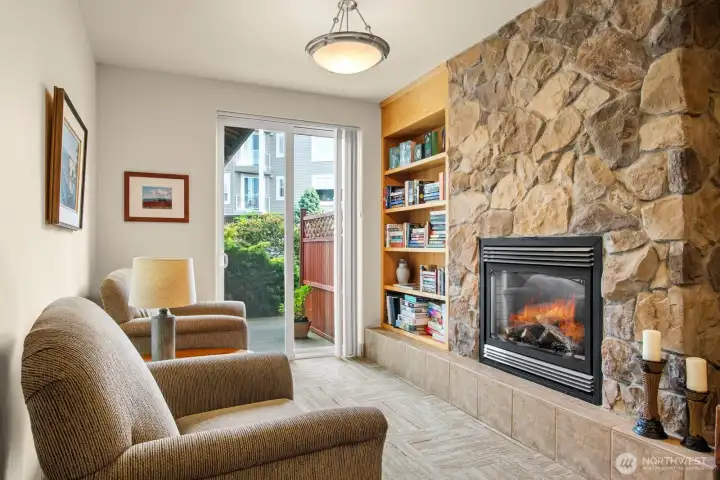 Sitting area with fire place and books, located in the common space area