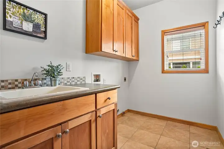 Main-floor laundry makes everyday chores a breeze. Don't miss the huge closet behind the door!