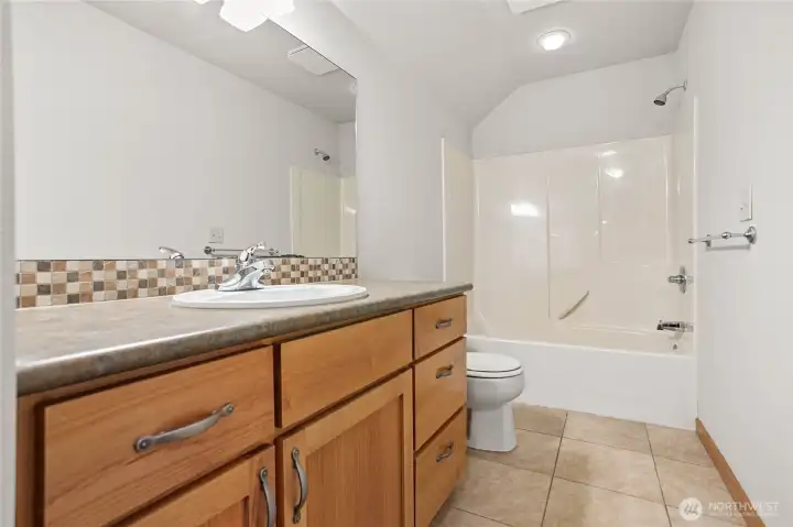 Upstairs bathroom is generously sized and has another huge closet