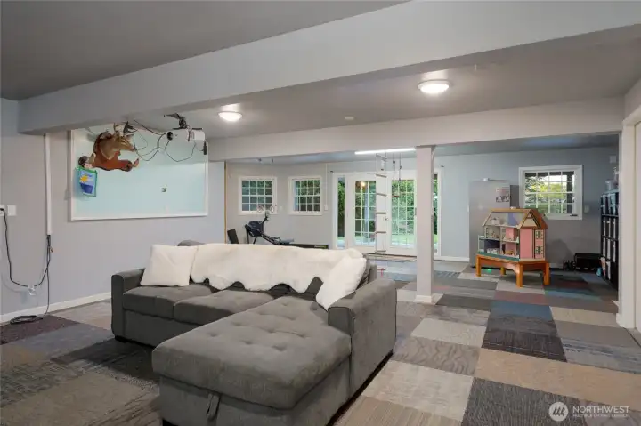 This lower-level space features a versatile entertainment center, a dedicated play area, and a functional workout room, with additional flexibility for hobbies or a second home office. This lower-level space features a versatile entertainment center, a dedicated play area, and a functional workout room, with additional flexibility for hobbies or a second home office.
